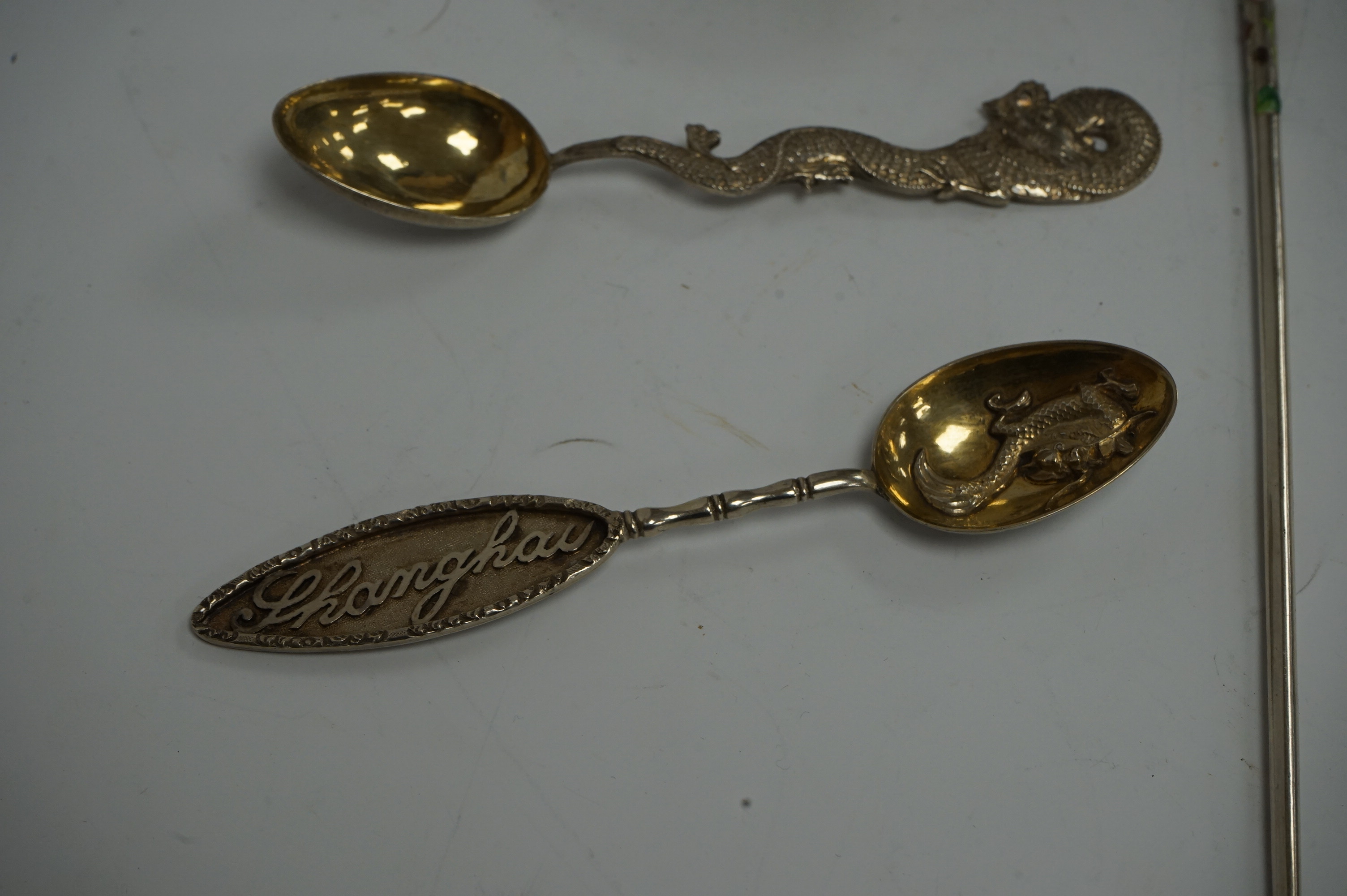 An early 19th century continental silver spoons, with embossed bowl and pieced terminal, import marks for Elly Isaac Miller, London, 1901, 17cm, together with two Chinese white metal spoons, one by Wang Hing and a pair o